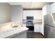 Modern kitchen featuring white cabinets, stainless steel appliances, and granite countertops at 10 Ne Perimeter Summit Ne Blvd # 4428, Brookhaven, GA 30319