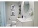 Cozy bathroom with a white sink, vanity and toilet, decorative mirror, and modern fixtures at 1788 Beacon Hill Ne Blvd, Atlanta, GA 30329