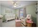 Light-filled Bedroom featuring a white crib, rocking chair, and soft, neutral tones at 1788 Beacon Hill Ne Blvd, Atlanta, GA 30329