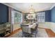 Elegant dining room featuring dark blue walls, modern chandelier, and seating for six at 1788 Beacon Hill Ne Blvd, Atlanta, GA 30329