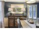 Stylish dining room featuring buffet cabinet with lamps, decor, natural light, and modern rug at 1788 Beacon Hill Ne Blvd, Atlanta, GA 30329