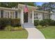 Close up of charming house, sidewalk, tidy landscaping, and a patriotic American flag at 1788 Beacon Hill Ne Blvd, Atlanta, GA 30329