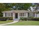 Charming single-story home with gray siding, black shutters, manicured lawn, and front garden at 1788 Beacon Hill Ne Blvd, Atlanta, GA 30329