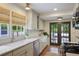 Bright kitchen with marble countertops, stainless steel appliances, and view of the outdoor patio at 1788 Beacon Hill Ne Blvd, Atlanta, GA 30329