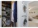 Convenient laundry area with stacked washer and dryer, shelving, and closet space at 1788 Beacon Hill Ne Blvd, Atlanta, GA 30329