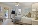 Spacious main bedroom with a ceiling fan, a sitting area, and doors that lead to the outside at 1788 Beacon Hill Ne Blvd, Atlanta, GA 30329