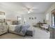 Tranquil main bedroom featuring neutral tones, sitting area, ceiling fan, and a view to the bathroom at 1788 Beacon Hill Ne Blvd, Atlanta, GA 30329