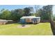 Expansive backyard featuring a fire pit, fenced perimeter, and lush lawn at 1961 Addison Ne Rd, Marietta, GA 30066