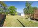Large backyard featuring an outbuilding, full perimeter fence, a fire pit, and a back deck at 1961 Addison Ne Rd, Marietta, GA 30066
