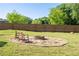 Backyard firepit area featuring a stone border and two wooden chairs at 1961 Addison Ne Rd, Marietta, GA 30066