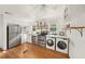 Updated kitchen featuring stainless steel appliances, white cabinets, and hardwood flooring at 1961 Addison Ne Rd, Marietta, GA 30066