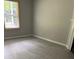 Bright bedroom with a window, gray walls, and hardwood flooring at 2919 Cushing Ct, Jonesboro, GA 30238
