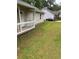 The home's front yard features green grass leading up to the porch with a burgundy vehicle in the distance at 2919 Cushing Ct, Jonesboro, GA 30238
