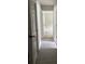 Hallway leading to a bedroom, featuring hardwood floors and multiple doors at 2919 Cushing Ct, Jonesboro, GA 30238