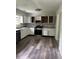 The spacious kitchen features white cabinets, stainless steel appliances, and stone countertops at 2919 Cushing Ct, Jonesboro, GA 30238