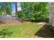 Large backyard featuring green grass, trees, wooden fence and patio at 2880 Cressington Nw Bnd, Kennesaw, GA 30144