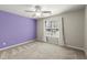 Bedroom with bright purple accent wall, neutral carpet, and large bright window at 2880 Cressington Nw Bnd, Kennesaw, GA 30144