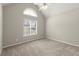 Bedroom featuring vaulted ceilings, large windows, and neutral carpeting at 2880 Cressington Nw Bnd, Kennesaw, GA 30144