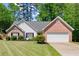 Attractive single-story home with brick and siding, complemented by a green lawn and fresh landscaping for curb appeal at 2880 Cressington Nw Bnd, Kennesaw, GA 30144