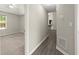 Hallway with view into bedroom featuring neutral carpeting and ceiling fan, and an open kitchen at 2880 Cressington Nw Bnd, Kennesaw, GA 30144