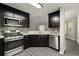 Modern kitchen features stainless appliances, dark cabinets, and sleek countertops, perfect for cooking at 2880 Cressington Nw Bnd, Kennesaw, GA 30144