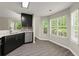 Kitchen with sleek dark cabinetry, stainless steel appliances, and sun-filled windows over the sink at 2880 Cressington Nw Bnd, Kennesaw, GA 30144