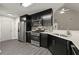Modern kitchen boasts stainless steel appliances, dark cabinets, quartz counters and stylish backsplash at 2880 Cressington Nw Bnd, Kennesaw, GA 30144