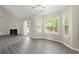Spacious living room features gray flooring, fireplace, vaulted ceilings, and large windows for natural light at 2880 Cressington Nw Bnd, Kennesaw, GA 30144