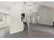 Bright open-concept living space features vaulted ceilings, gray flooring, and seamless access to dining area at 2880 Cressington Nw Bnd, Kennesaw, GA 30144