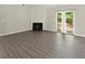Bright, open living room with a fireplace, new vinyl floors, and a sliding door to the patio at 2880 Cressington Nw Bnd, Kennesaw, GA 30144