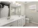 Bright main bathroom features dual sinks, white cabinets, and abundant natural light at 2880 Cressington Nw Bnd, Kennesaw, GA 30144