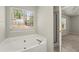 Main bathroom offers a soaking tub, a walk-in shower and view to the main bedroom at 2880 Cressington Nw Bnd, Kennesaw, GA 30144