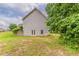 Wide view of a spacious, green backyard and the back of the house at 51 Legend Creek Way, Douglasville, GA 30134