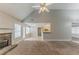 Spacious living room with a stone fireplace and large windows providing ample natural light at 51 Legend Creek Way, Douglasville, GA 30134