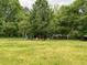 Large backyard with mature trees providing ample shade, toys are in the background at 6192 Meadowbrook Dr, Norcross, GA 30093