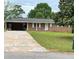 Charming single story brick home with attached carport and a well maintained lawn at 6192 Meadowbrook Dr, Norcross, GA 30093