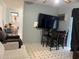 An open living room shows a TV, table, sofa, and chair; ceiling fan is also visible at 6192 Meadowbrook Dr, Norcross, GA 30093