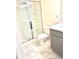 Bathroom with modern marble tile, glass enclosed shower, and vanity at 6318 Scudders Dr, Lithonia, GA 30058
