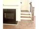 Close up of the fireplace and staircase with hardwood floors and white trim at 6318 Scudders Dr, Lithonia, GA 30058