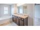Bathroom with a soaking tub, a double sink vanity, and tile flooring at 1003 Eldon Ln, Fairburn, GA 30213