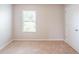 Bedroom with neutral carpet, a window, and a white door at 1003 Eldon Ln, Fairburn, GA 30213