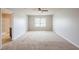 Spacious bedroom featuring neutral carpet, ceiling fan, and a large window at 1003 Eldon Ln, Fairburn, GA 30213