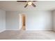 Bedroom featuring neutral carpet, ceiling fan, and access to an en suite bathroom at 1003 Eldon Ln, Fairburn, GA 30213