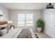Cozy bedroom featuring plush bedding, natural light, and a stylish accent plant at 1003 Eldon Ln, Fairburn, GA 30213
