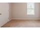 Bedroom featuring neutral walls, carpeted floors, and natural light from a window at 1003 Eldon Ln, Fairburn, GA 30213
