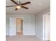 Bedroom featuring neutral carpet, ceiling fan, and access to other rooms at 1003 Eldon Ln, Fairburn, GA 30213