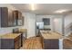 Modern kitchen features stainless appliances, granite countertops, wood cabinets and an island with a sink at 1003 Eldon Ln, Fairburn, GA 30213