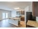Modern kitchen features stainless appliances, granite countertops, wood cabinets and an island with a sink at 1003 Eldon Ln, Fairburn, GA 30213