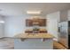 Modern kitchen features stainless appliances, granite countertops, wood cabinets and an island with a sink at 1003 Eldon Ln, Fairburn, GA 30213