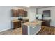 Modern kitchen features stainless appliances, granite countertops, wood cabinets and an island with a sink at 1003 Eldon Ln, Fairburn, GA 30213